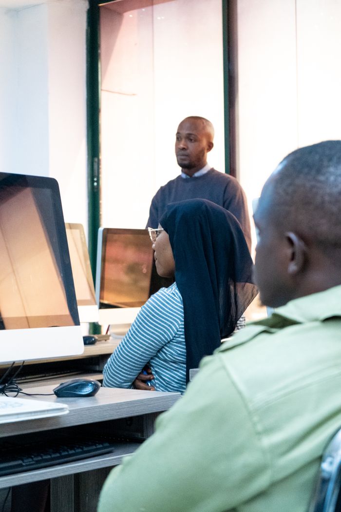 why-choose-us Students engaging in coding at a modern computer lab with a focus on ICT skills.